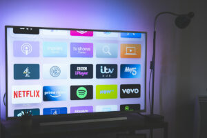 Television with streaming apps on screen in a dark room.